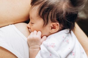 An intimate scene of a baby breastfeeding, showcasing maternal love and care.